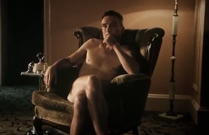 Naked Oppenheimer in a Chair
